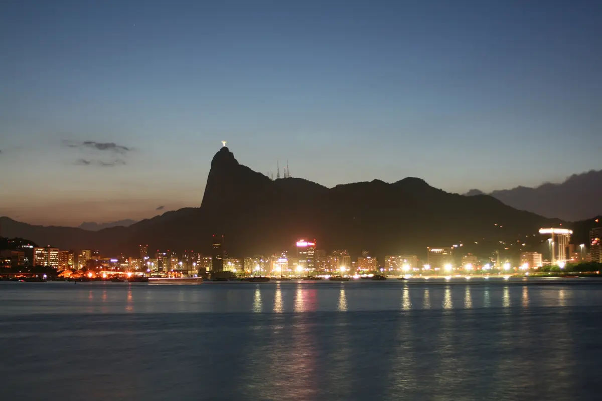 Rio's waterfront at night with the lit statue on Corcovado